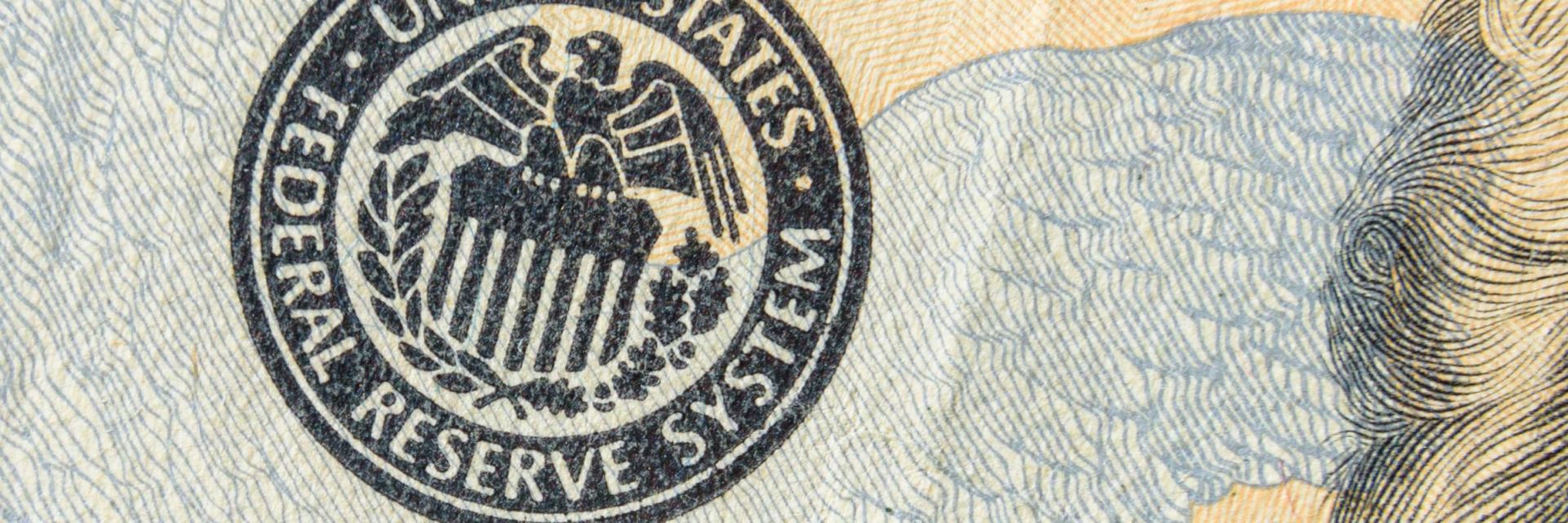 Federal Reserve stamp on dollar.